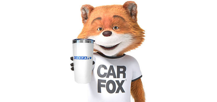 Car Fox holding a coffee cup